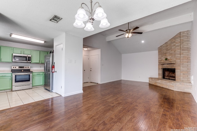 unfurnished living room with lofted ceiling with beams, ceiling fan with notable chandelier, light hardwood / wood-style flooring, and a fireplace