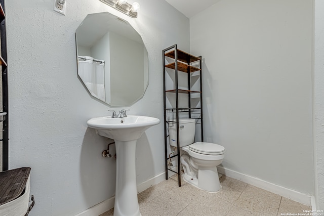 bathroom featuring toilet and tile patterned floors