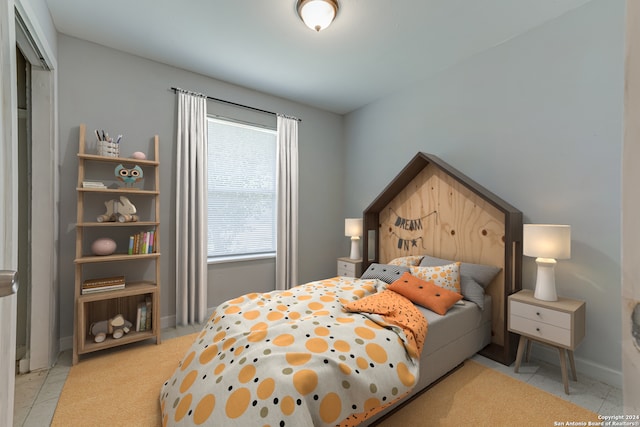 bedroom featuring light tile patterned flooring