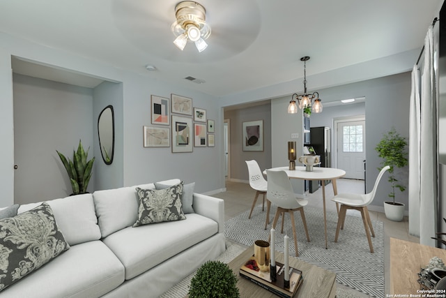 living room with ceiling fan with notable chandelier and tile patterned floors