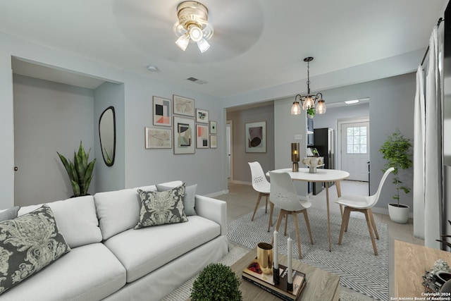 living area with visible vents, baseboards, and a ceiling fan