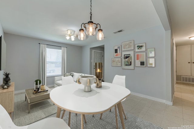 dining room with a notable chandelier and light tile patterned floors