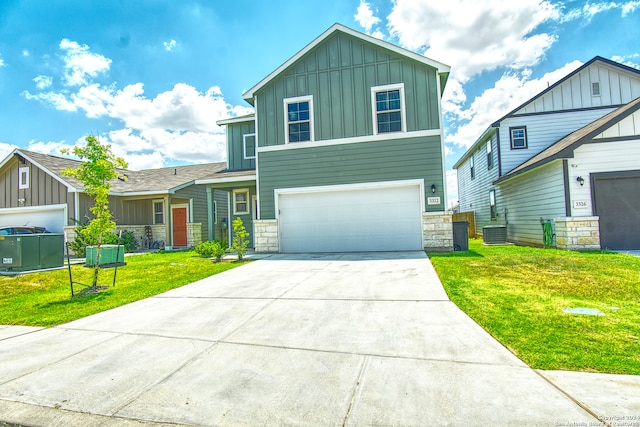 view of front of house with a front lawn, central AC, and a garage