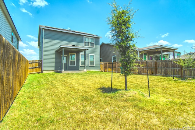 rear view of house with a lawn