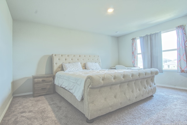 bedroom featuring light carpet