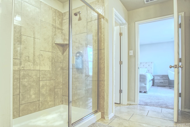 bathroom featuring a shower with shower door and tile patterned floors