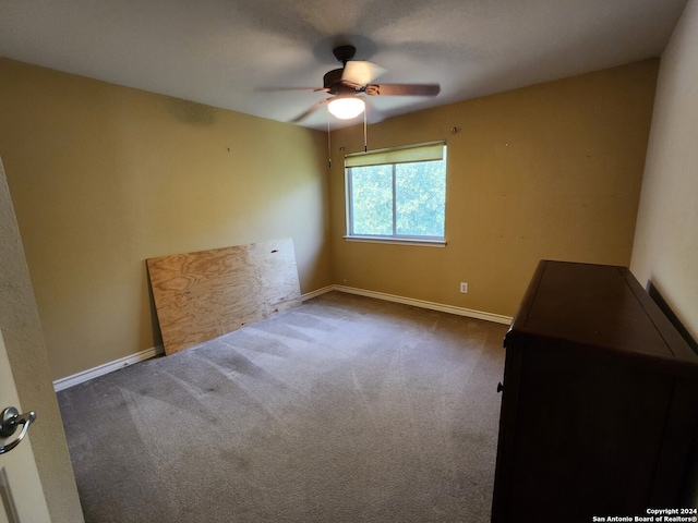 spare room featuring carpet flooring and ceiling fan