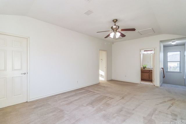 carpeted empty room featuring ceiling fan and vaulted ceiling