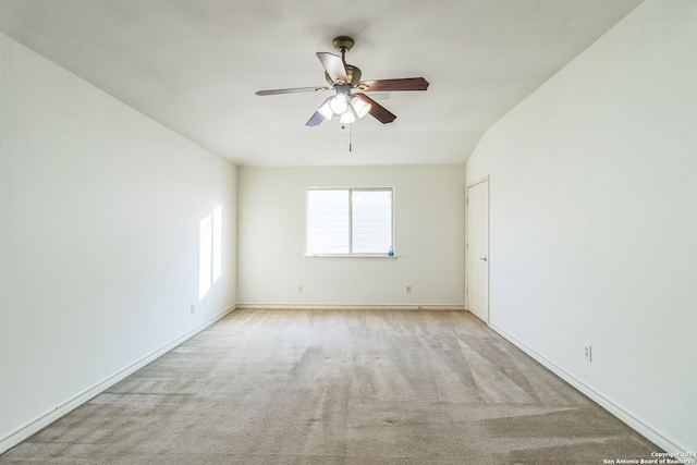 unfurnished room featuring light carpet, lofted ceiling, and ceiling fan