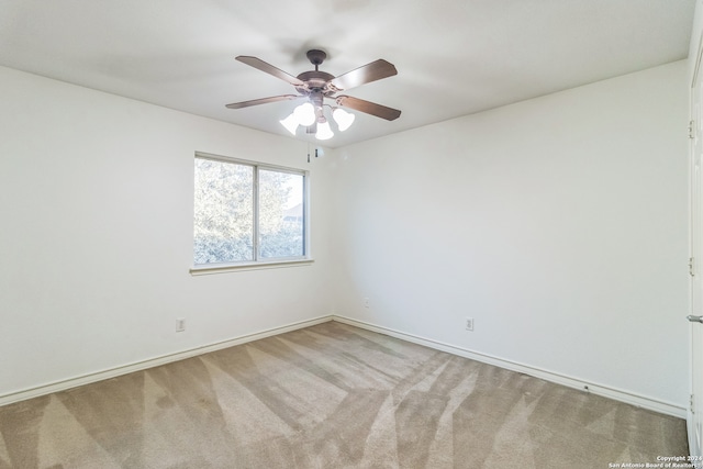 empty room featuring carpet flooring and ceiling fan