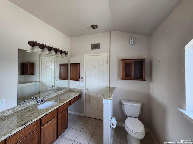 bathroom featuring vanity, toilet, and tile patterned floors