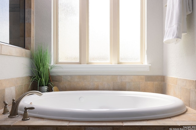 bathroom with tiled tub