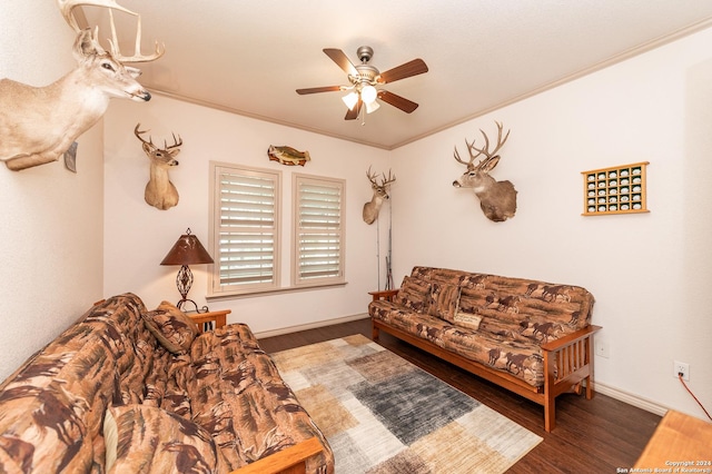 living room with a ceiling fan, crown molding, baseboards, and wood finished floors