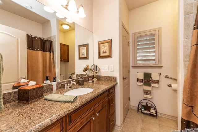 bathroom with a shower with curtain, tile patterned flooring, vanity, and baseboards