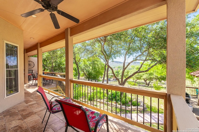 exterior space with fence and a ceiling fan