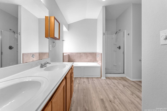 bathroom featuring hardwood / wood-style flooring, plus walk in shower, lofted ceiling, and dual bowl vanity