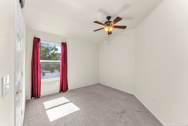 carpeted empty room featuring ceiling fan and lofted ceiling