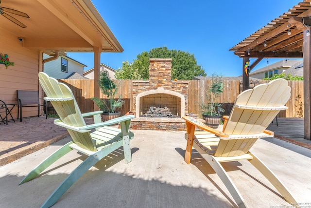 view of patio / terrace featuring a pergola and an outdoor stone fireplace