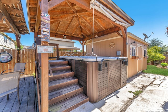 wooden terrace with a gazebo and a hot tub