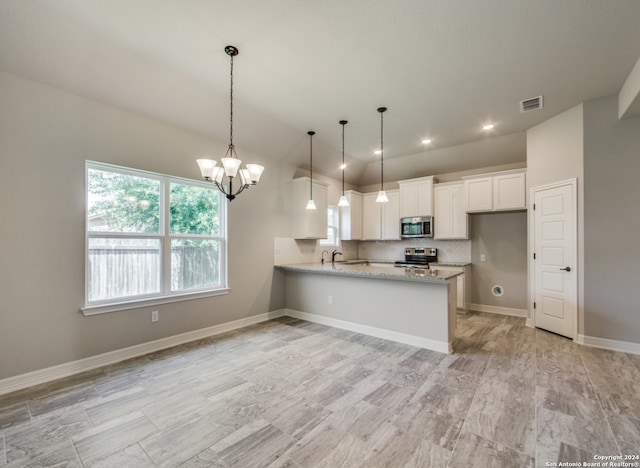 kitchen with stainless steel appliances, decorative backsplash, light stone countertops, white cabinets, and kitchen peninsula