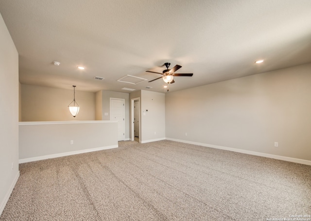 spare room with ceiling fan and light carpet