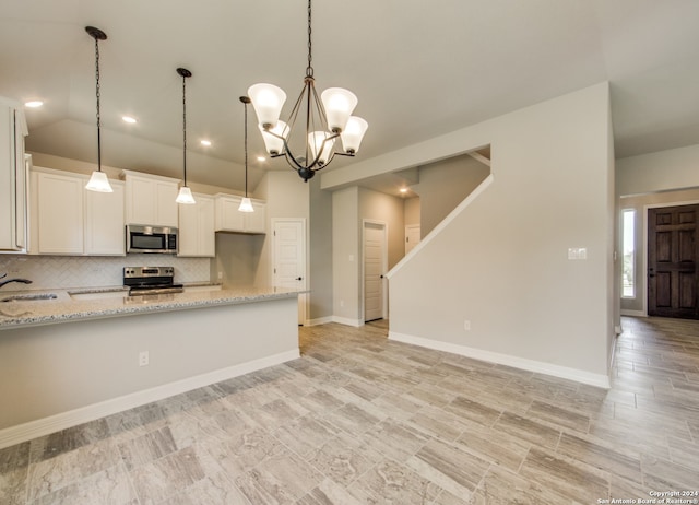 kitchen featuring sink, decorative backsplash, light stone counters, white cabinetry, and stainless steel appliances