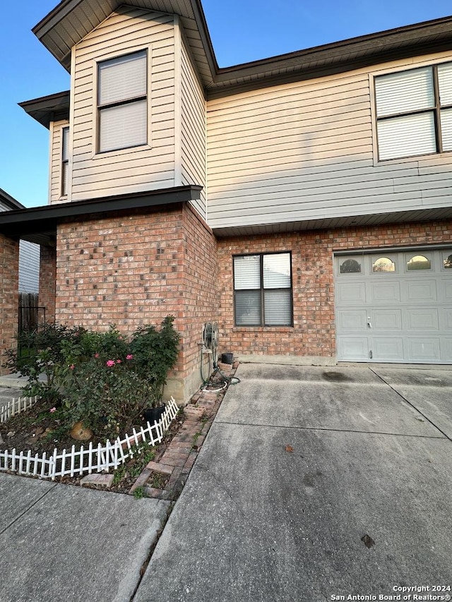 view of front of home with brick siding and an attached garage