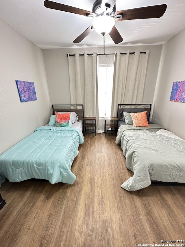 bedroom featuring a ceiling fan and wood finished floors