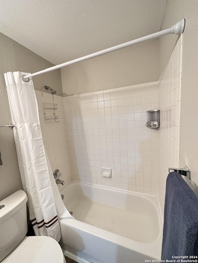 bathroom with shower / bath combo, a textured wall, a textured ceiling, and toilet