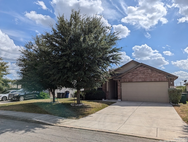 obstructed view of property with a front yard and a garage