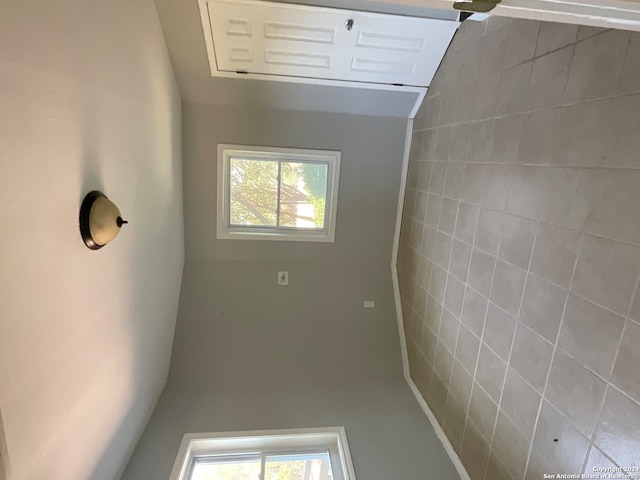 unfurnished room featuring vaulted ceiling