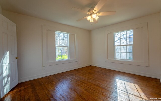 empty room featuring hardwood / wood-style flooring and ceiling fan