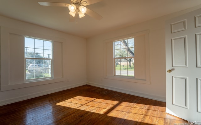 unfurnished room with ceiling fan, a wealth of natural light, and hardwood / wood-style flooring