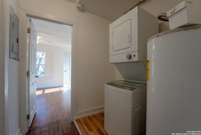 washroom featuring stacked washer and dryer, ceiling fan, and wood-type flooring