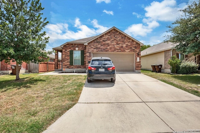 view of front facade with a garage, brick siding, fence, driveway, and a front yard