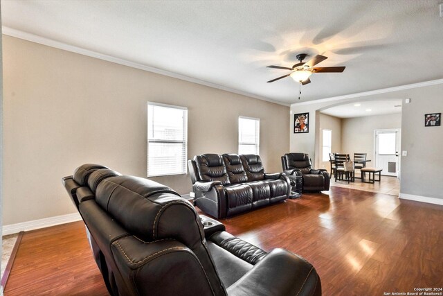 tiled living room featuring ceiling fan and ornamental molding