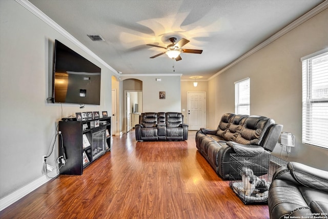 living room with ceiling fan, wood-type flooring, and ornamental molding