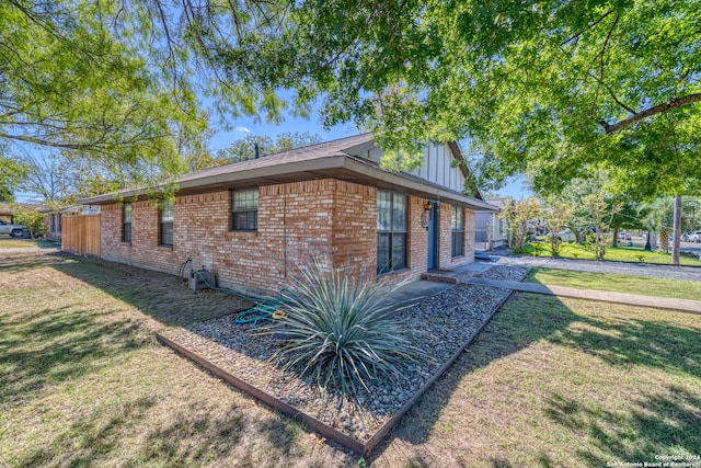 view of side of property with a lawn