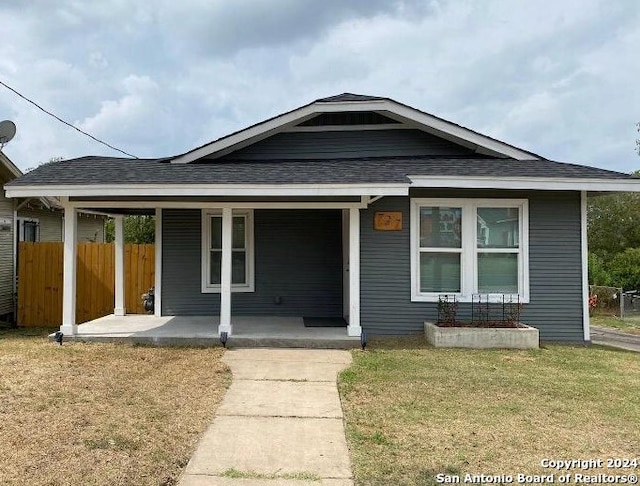 bungalow-style house with a front lawn