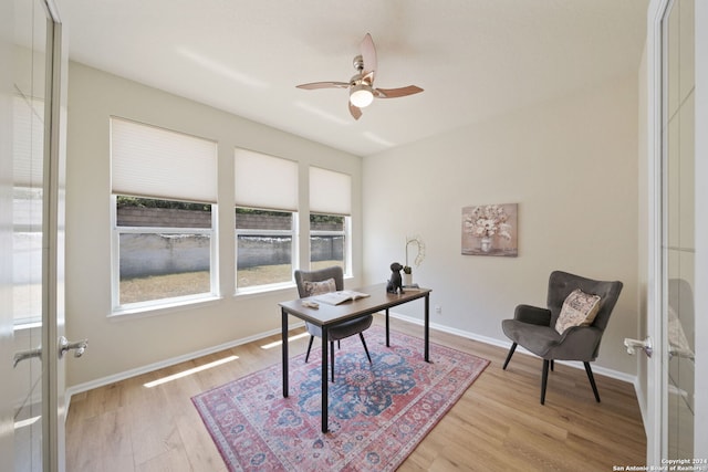 home office featuring ceiling fan, french doors, and light hardwood / wood-style floors