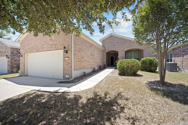 view of front of property with central AC and a garage