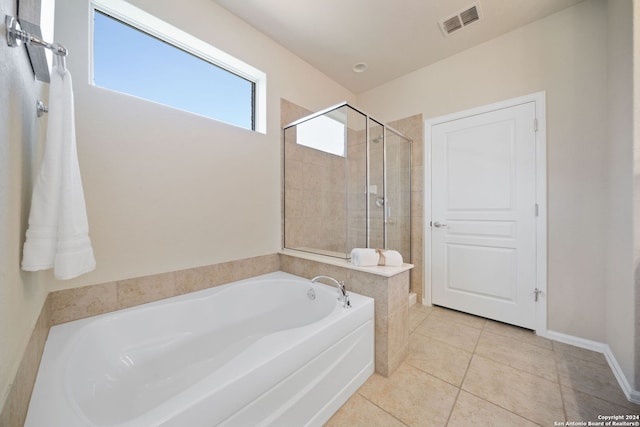 bathroom with tile patterned floors and plus walk in shower