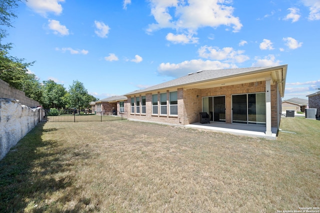 back of house featuring a patio and a yard