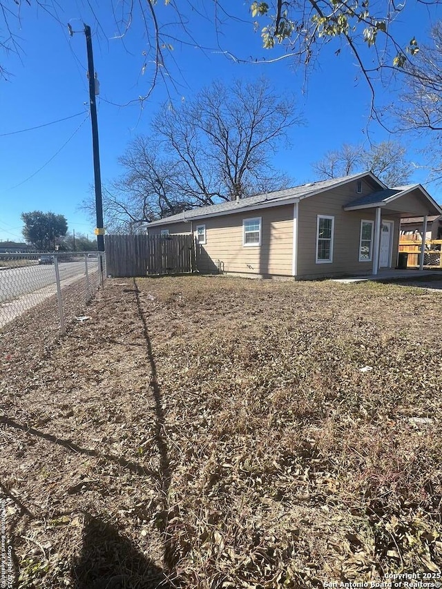 view of property exterior featuring fence