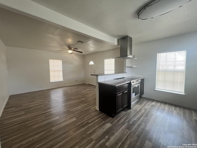 kitchen with electric range, visible vents, island range hood, dark cabinets, and light countertops