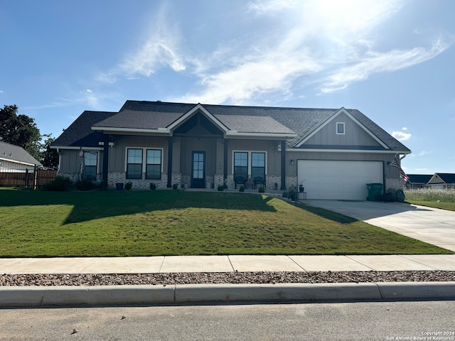 craftsman-style house with a garage and a front lawn