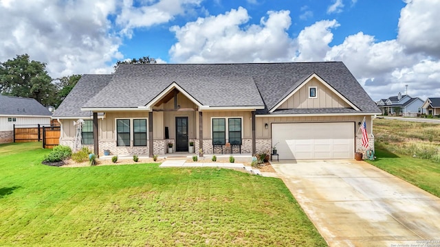 craftsman-style house featuring a garage, a porch, and a front lawn