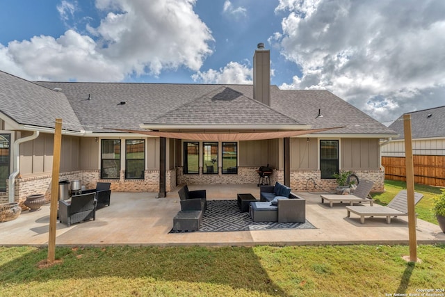 back of property with a yard, outdoor lounge area, and a patio