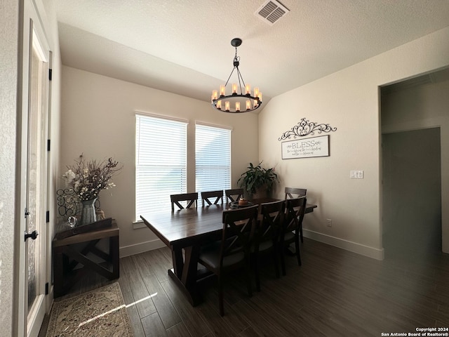 dining space with dark hardwood / wood-style floors, a chandelier, and a textured ceiling