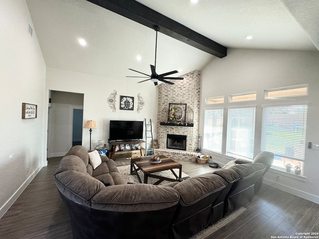 living room featuring beamed ceiling, a textured ceiling, a brick fireplace, ceiling fan, and dark hardwood / wood-style floors